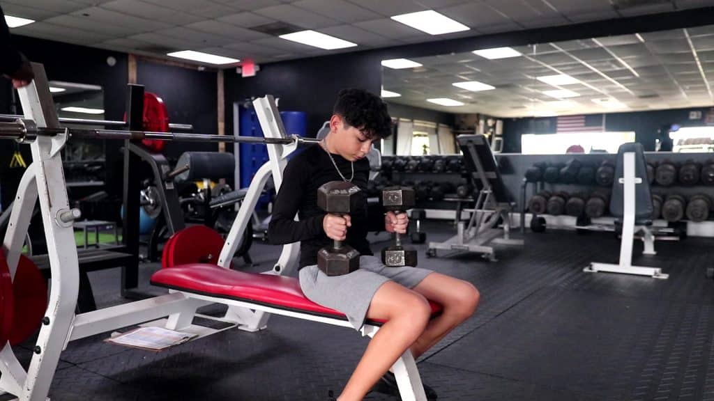 Young athlete in New Port Richey performing safe strength training under coach supervision